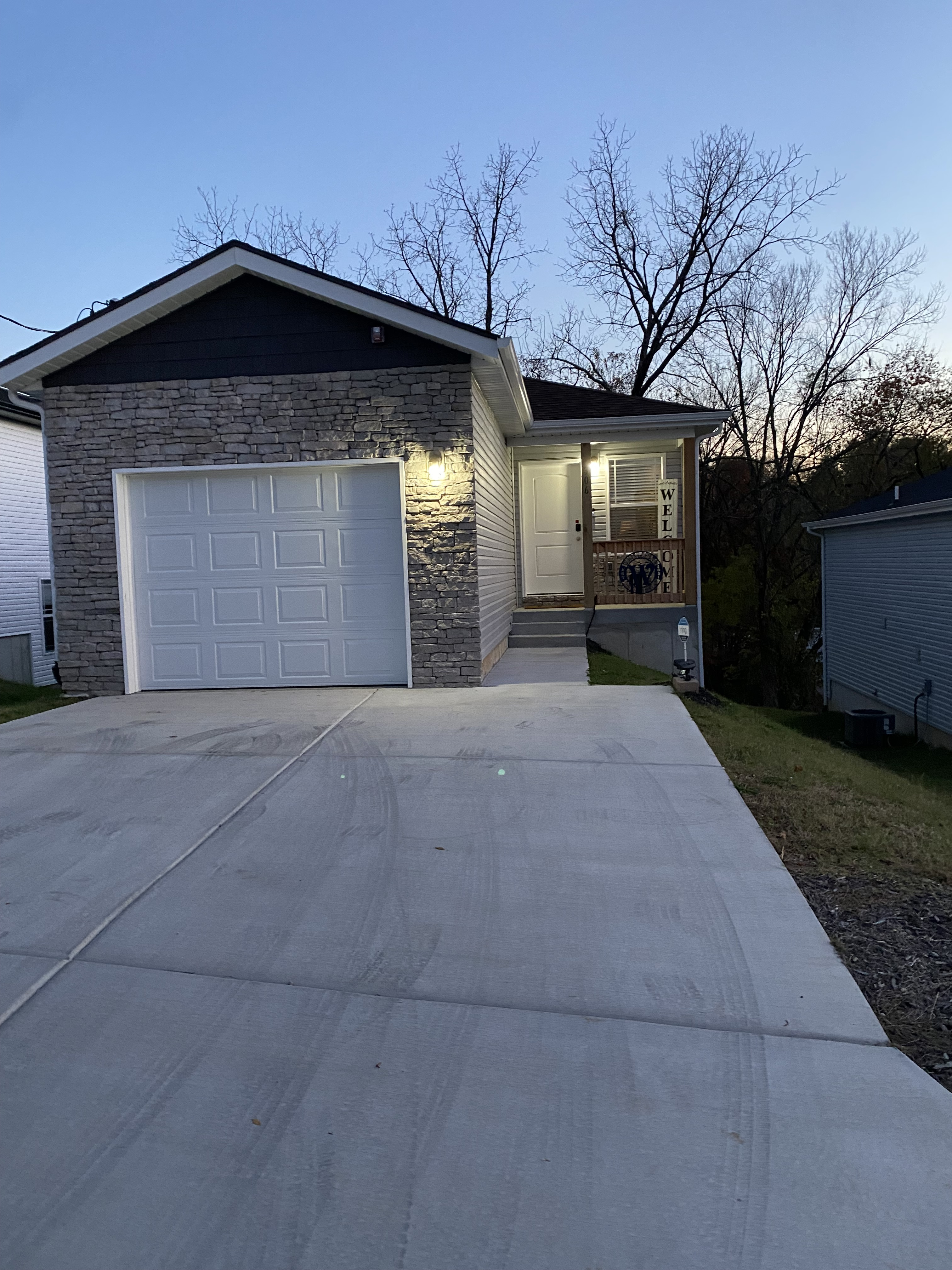 well lit entrance with additional security landscape lights