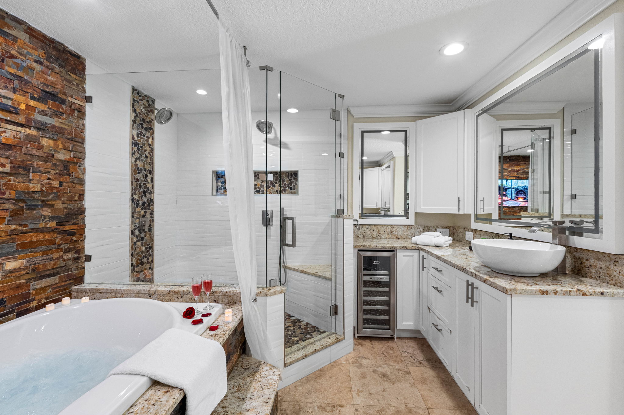 The spacious layout includes his and hers sinks, providing ample counter space and convenience for couples or guests sharing the space.