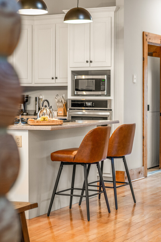 Gather for meals in the dining area with rustic cabin charm, plenty of seating, and natural light pouring in from the windows.