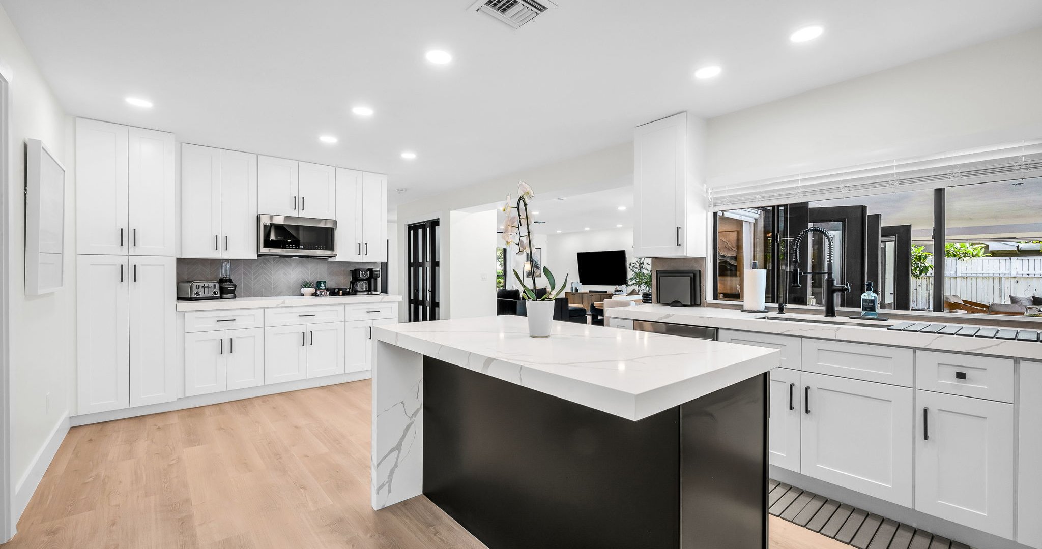Bright and airy, this modern kitchen combines luxury finishes with everyday comfort. Enjoy the designer backsplash, expansive counter space, and seamless flow to the dining and living areas.