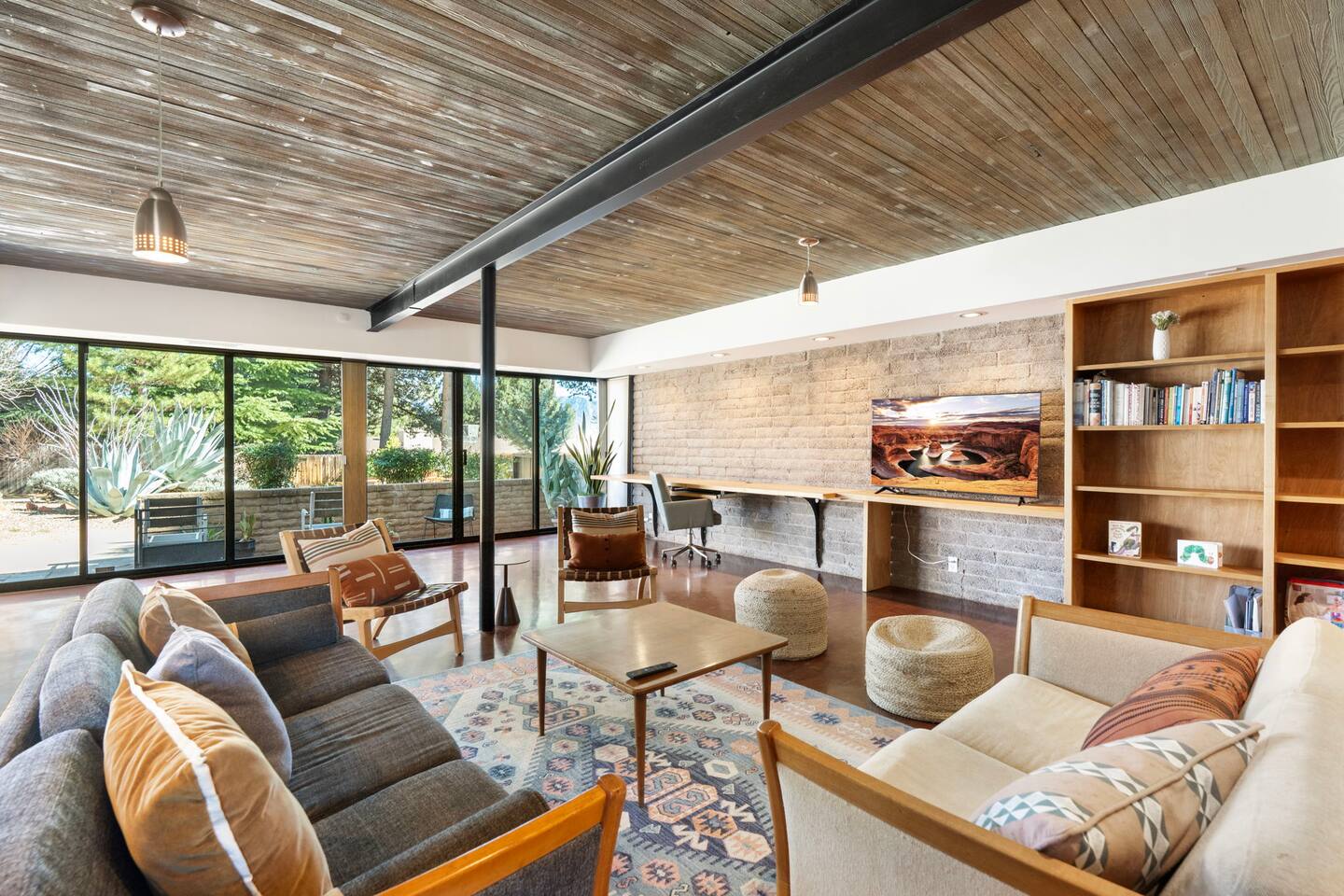 Spacious open living area with warm wood ceilings and inviting mid-century charm.