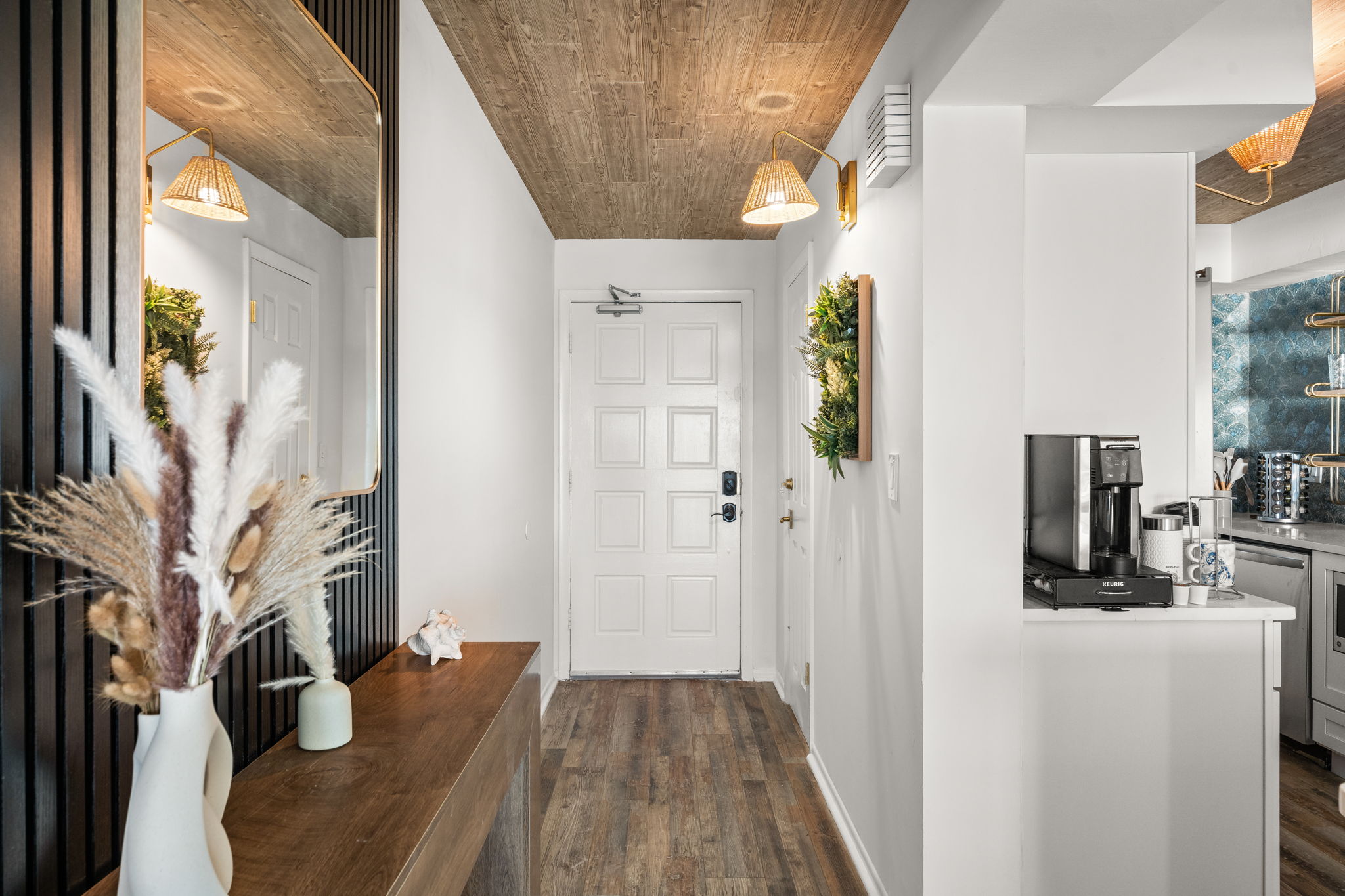 Private entrance, reception table, coffee station and designer chefs kitchen