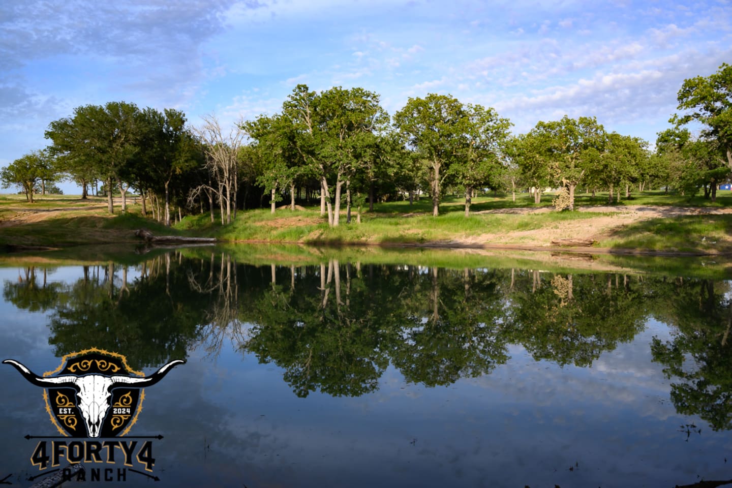 A view of the pond and game center that features a pickleball court