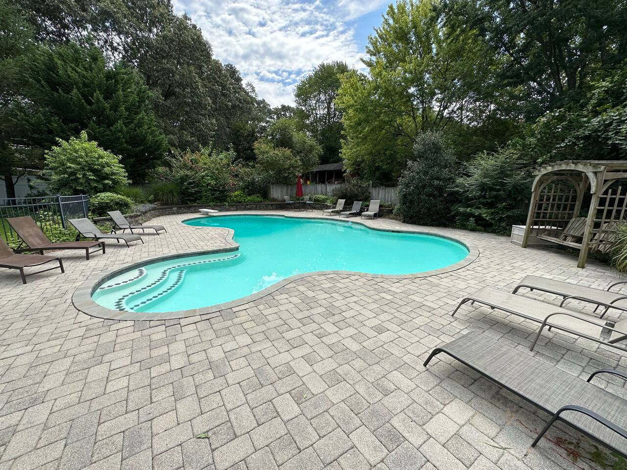 Pool with plenty of lounge chairs and swing