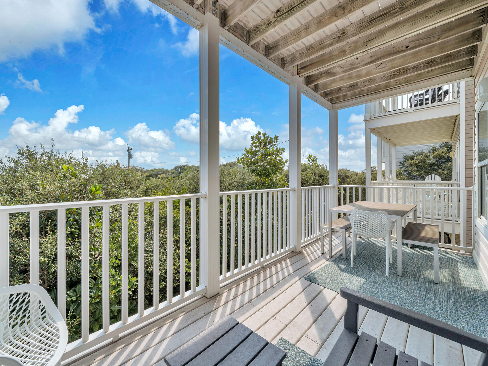 Dine al fresco on the second-floor balcony, which sits off the family room and overlooks 30A and the gulf