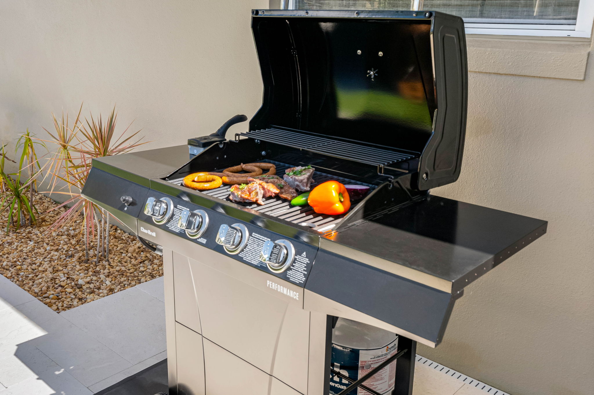 Relax, grill, and dine al fresco in this outdoor oasis featuring a sparkling heated pool and cozy dining area.