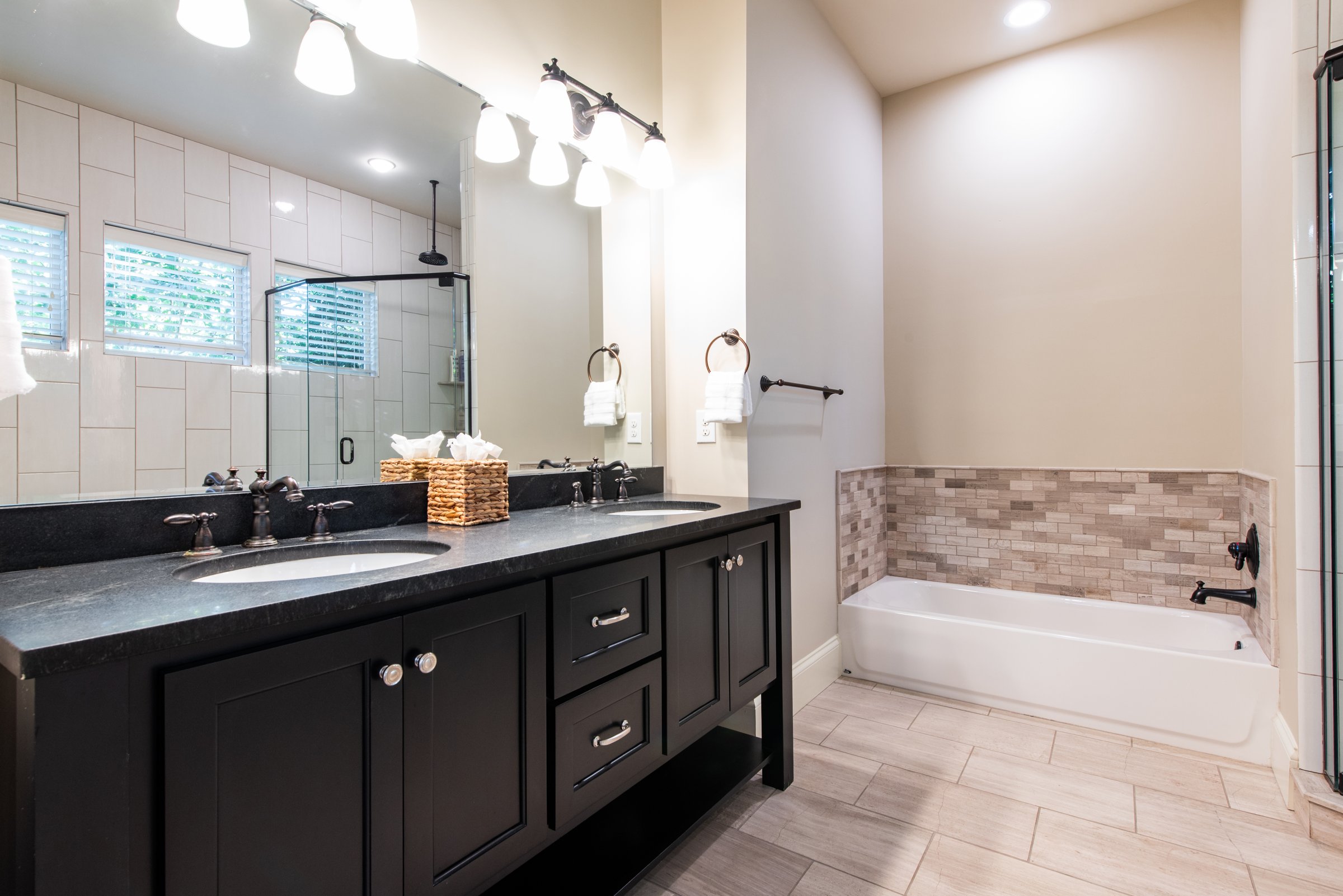Private ensuite bath with vanity and soaking tub.