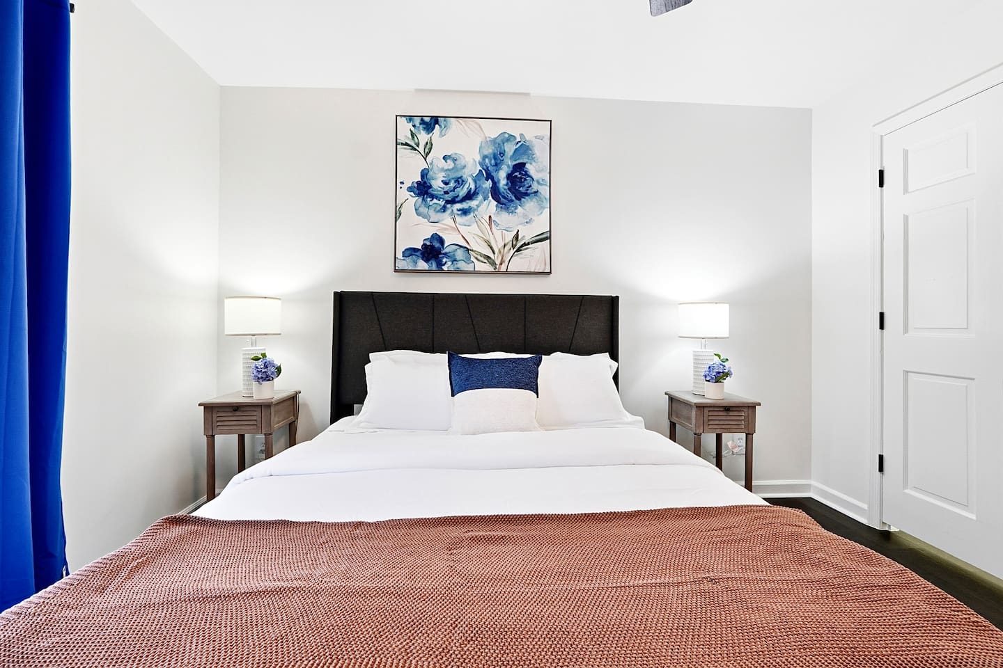 Upstairs bedroom located to the right, featuring a floral-inspired design and a comfortable double bed. Includes a smart TV and easy access to a shared bathroom. This room includes 2 full-body towels, 2 washcloths, and 2 hand towels for your stay.