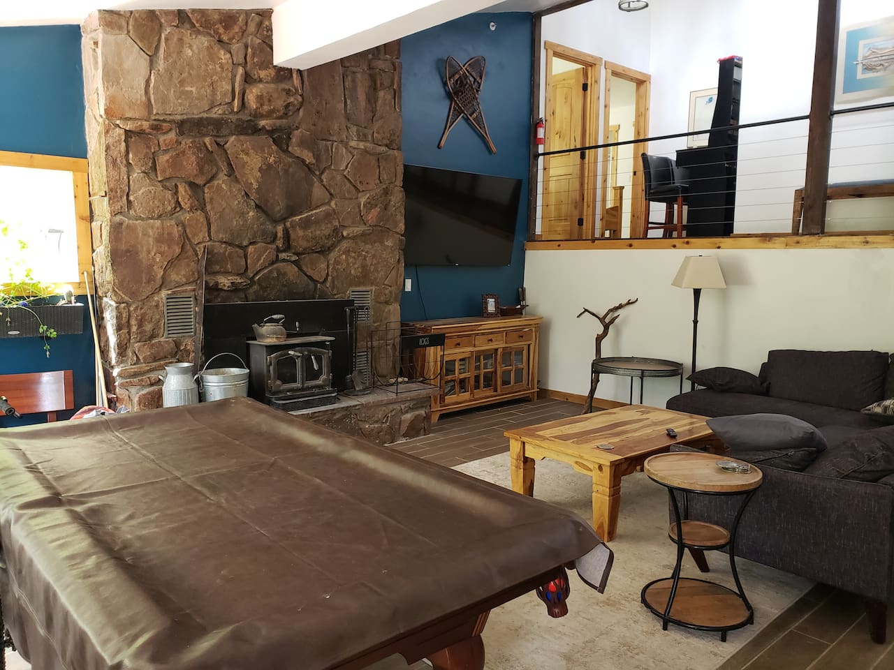 Main living room with 70" tv fireplace and pool table. 