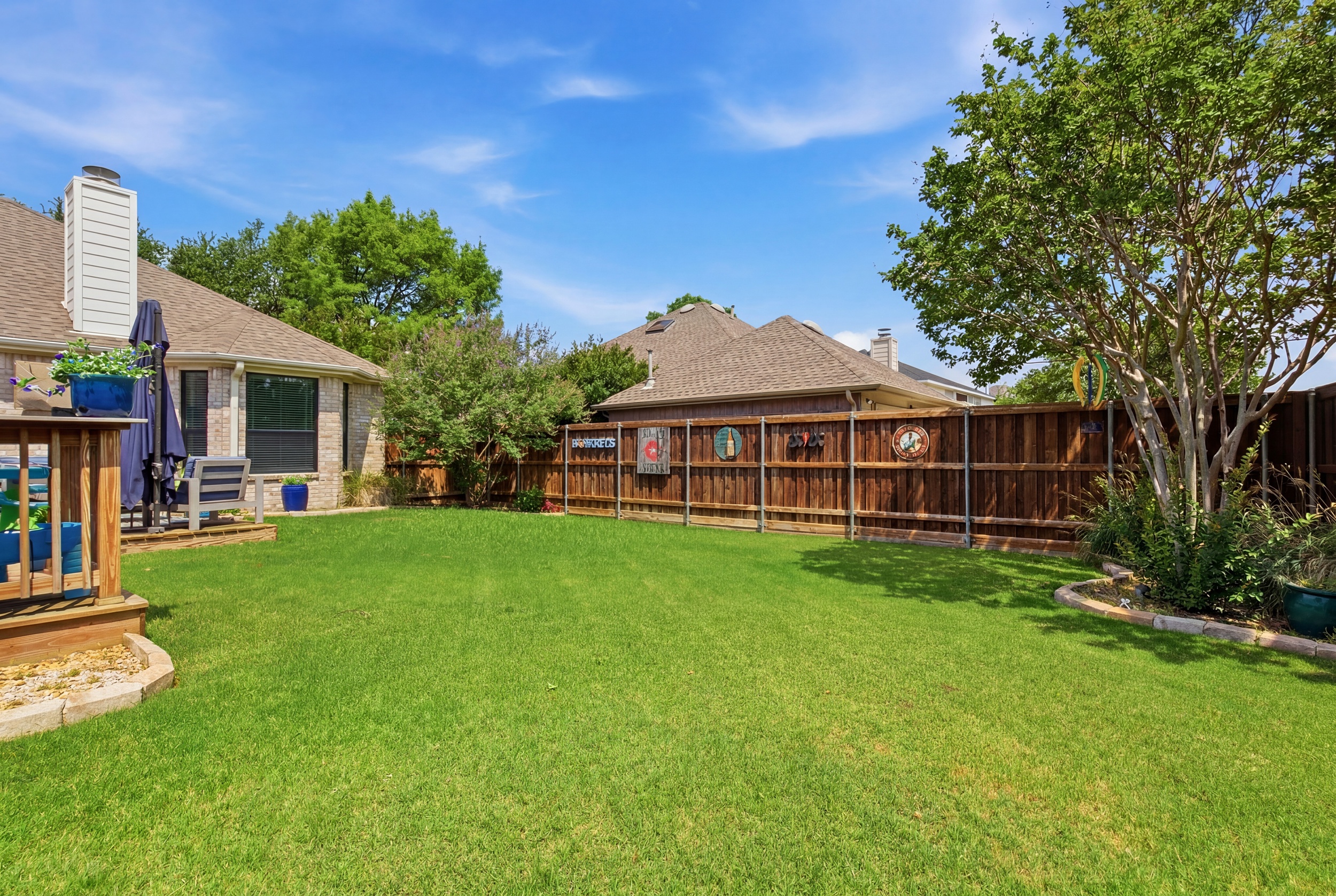 Lush green Backyard with tall trees and a privacy fence. Plenty of open space for kids to play, with the Patio and propane BBQ Grill just steps from the back door.
