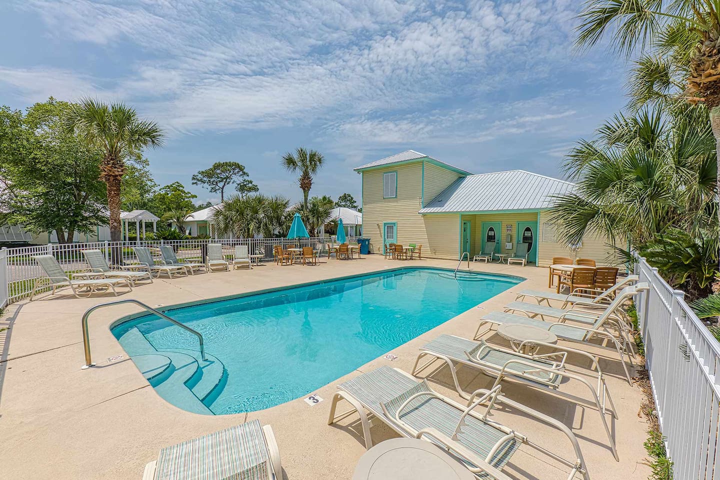 Poolside Paradise: Dive into relaxation with palm trees, lounging chairs, and bright sunny skies!