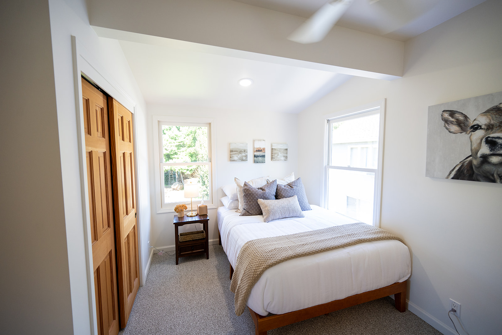 Second bedroom featuring a queen bed with comfortable linens and a quiet, relaxing atmosphere