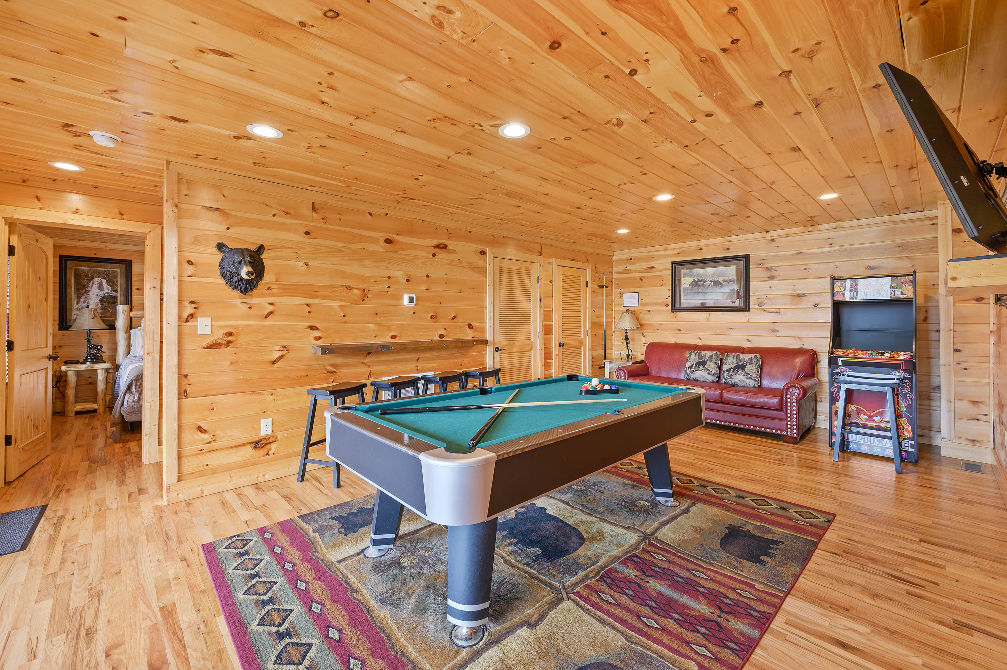 Lower level game room: Pool table and 2 multi-cade arcade games