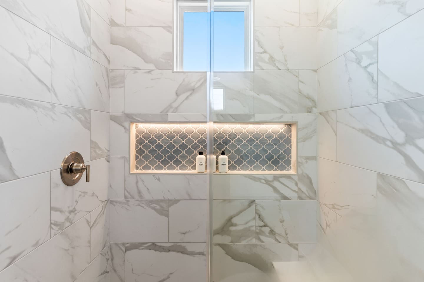 Thoughtfully designed for every guest, each bathroom features spacious curbless showers with built-in benches, blending accessibility with modern comfort and style.