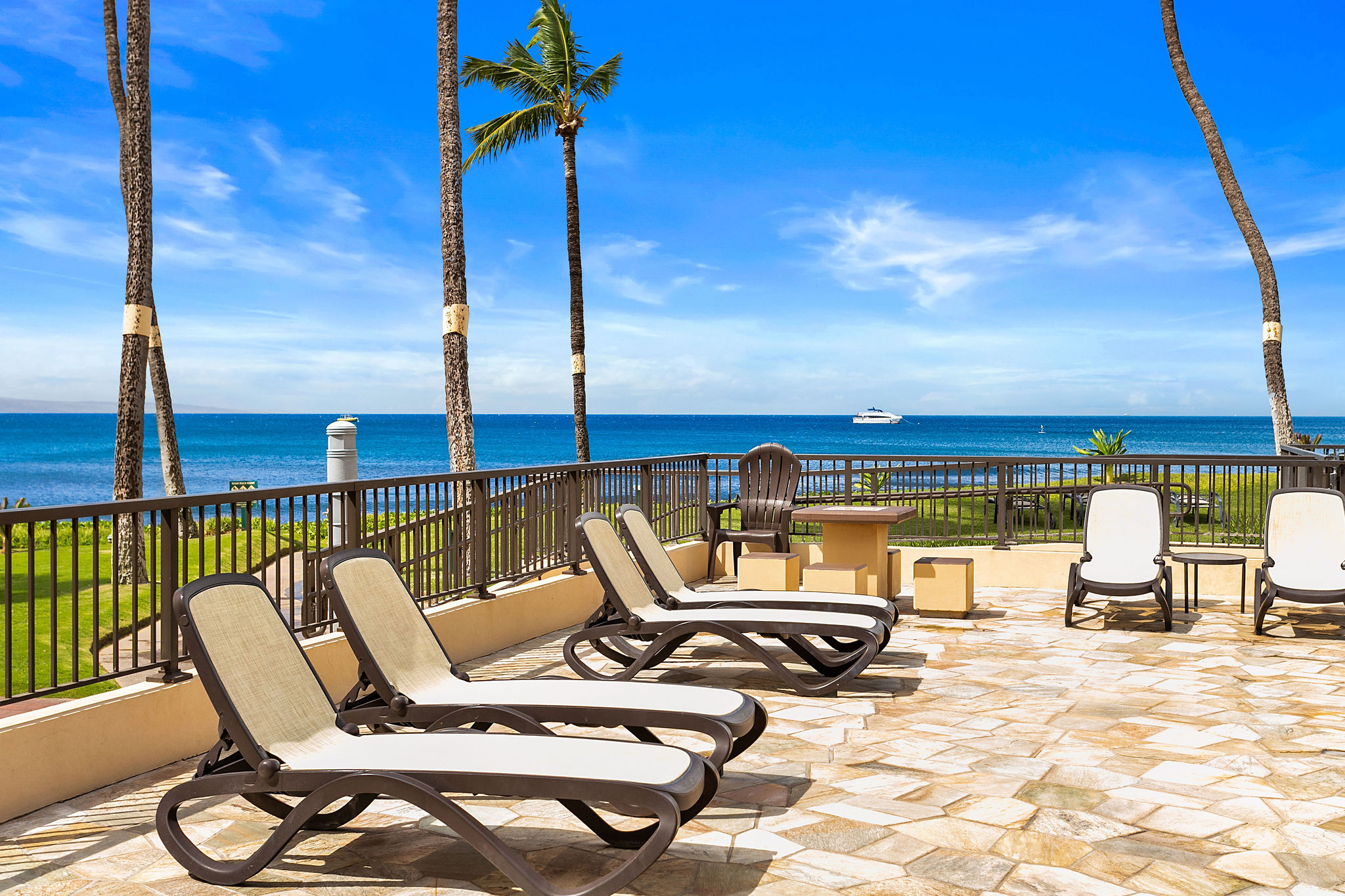 The oceanfront pool area with chaise lounges