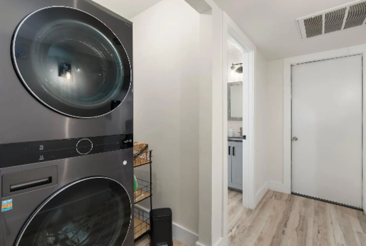 A stacked washer and dryer keep longer stays easy, tucked neatly just off the main hallway.