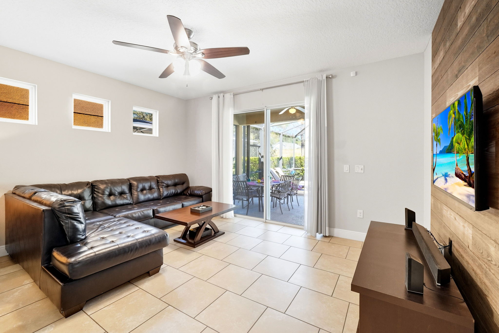Living room alternate view. Sliding doors alert you when someone opens them to head out to the pool.