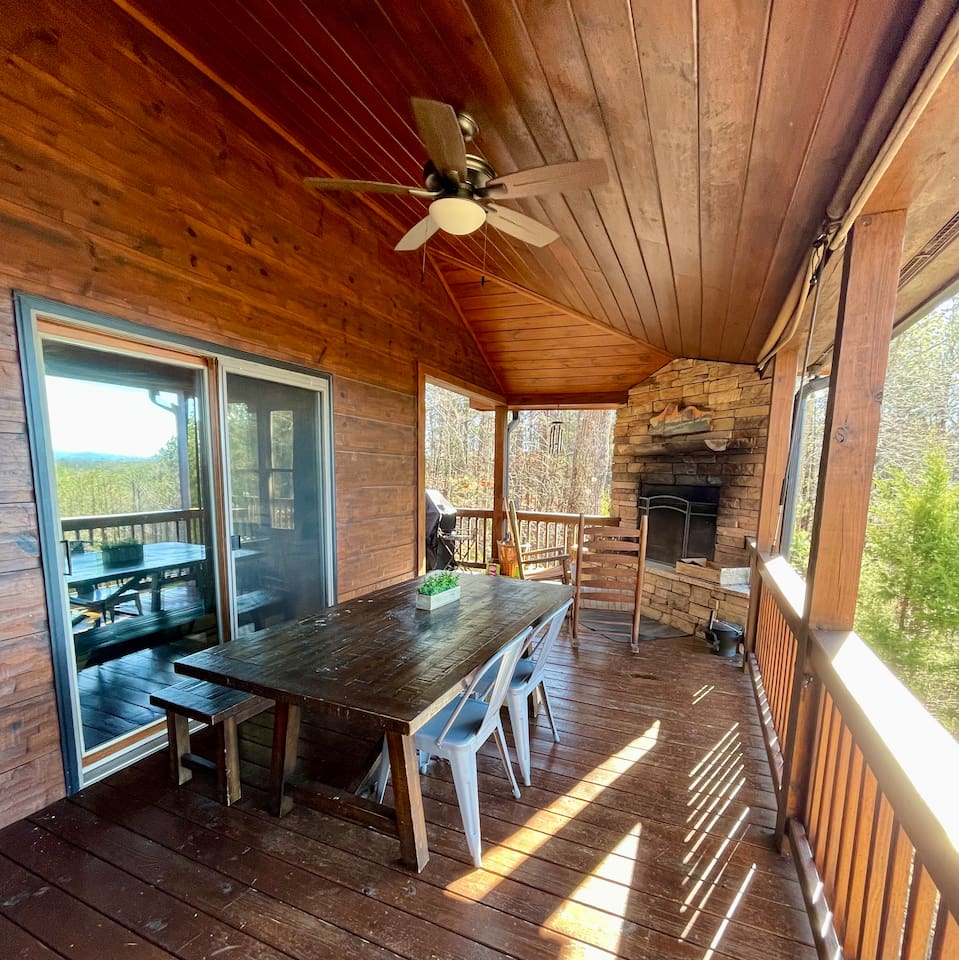 Outdoor wood-burning fireplace and outdoor dining table on the back deck with mountain views!