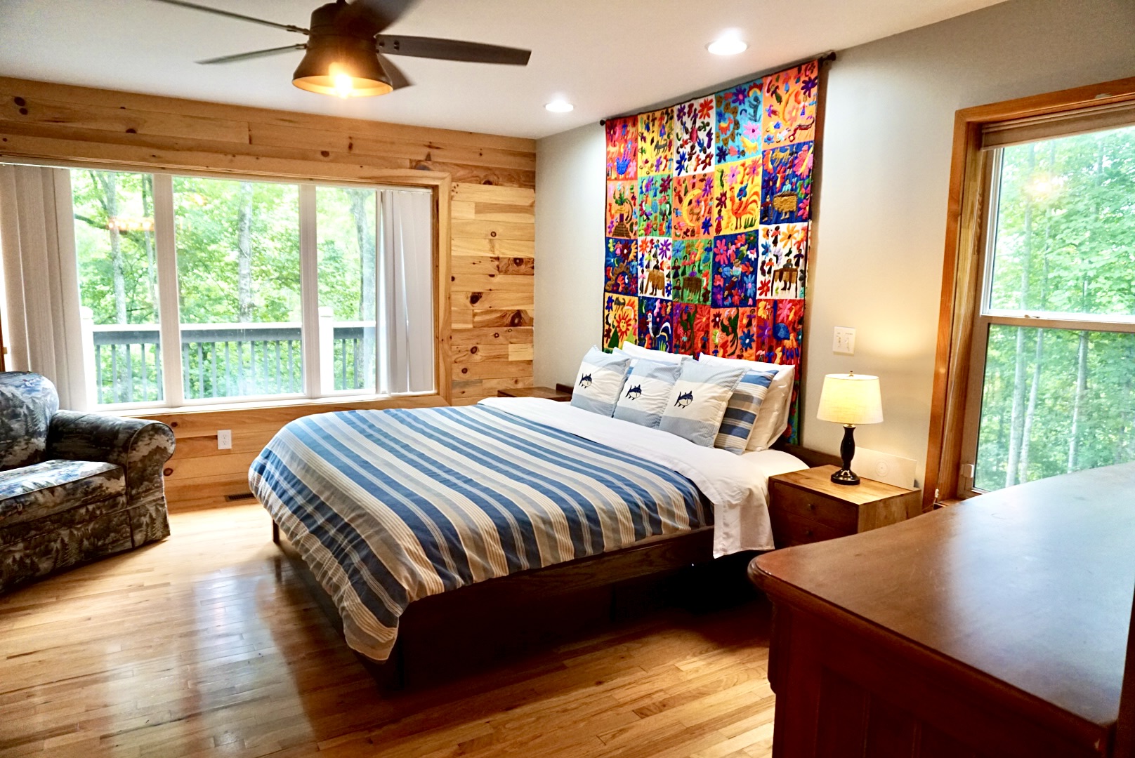 Bedroom Retreat: Bright space with artful decor, forest views, and plush furnishings await you!