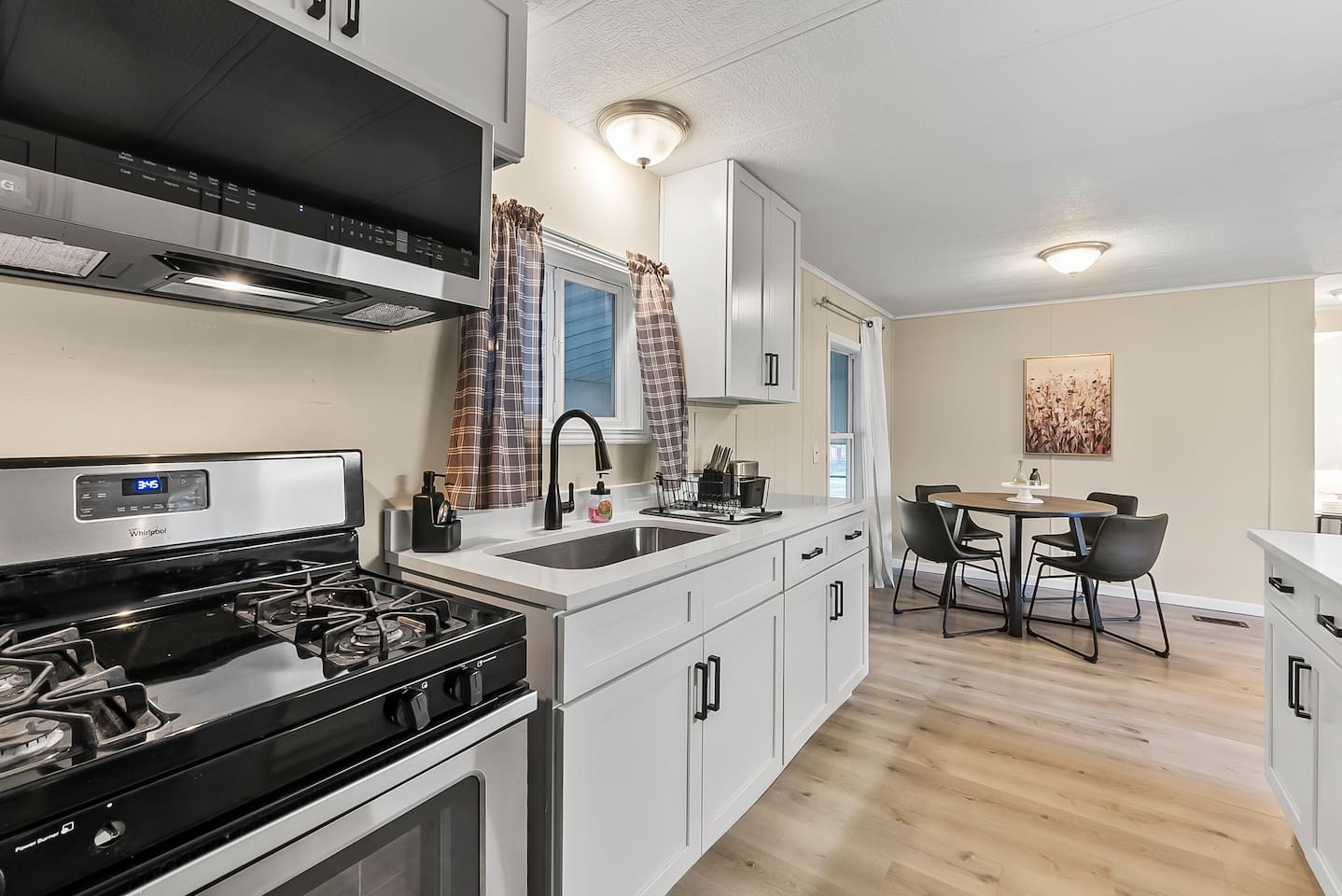 Bright kitchen with gas stove and deep sink, making meal prep simple and convenient.