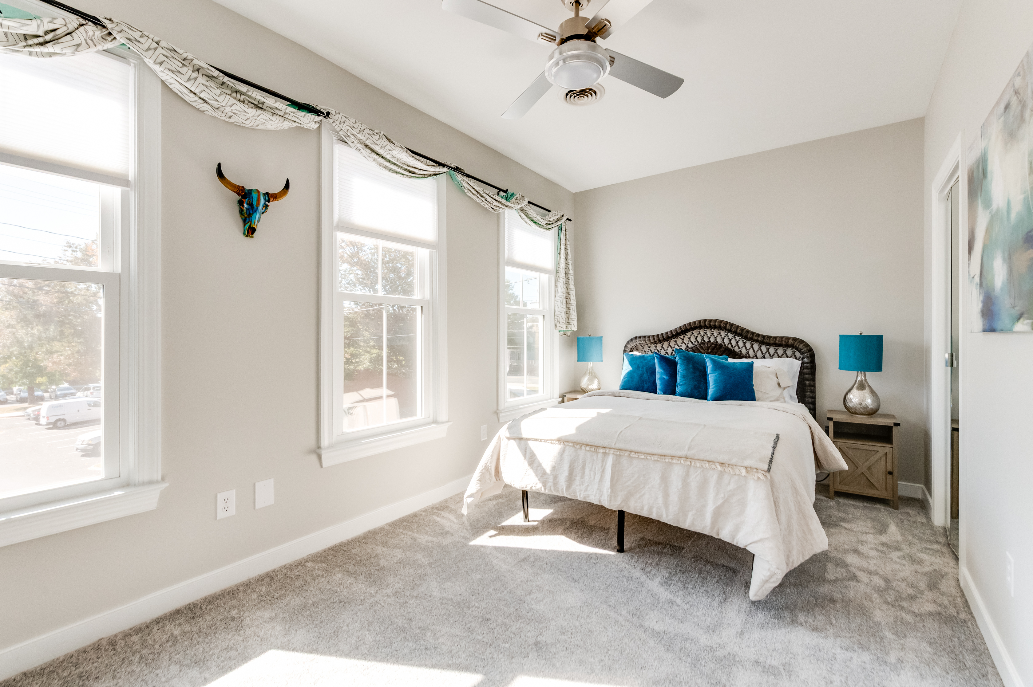 Queen Bedroom 2: Bright room with plush bedding, stylish decor, and sunny views for relaxation.