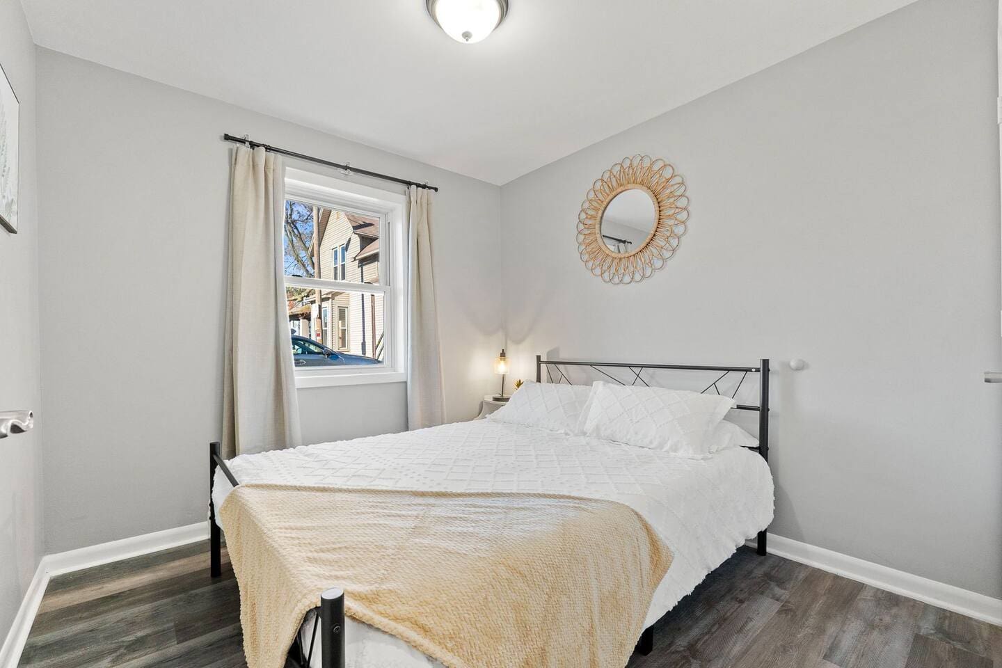 Cozy bed positioned next to a window, offering a peaceful view and plenty of natural light.