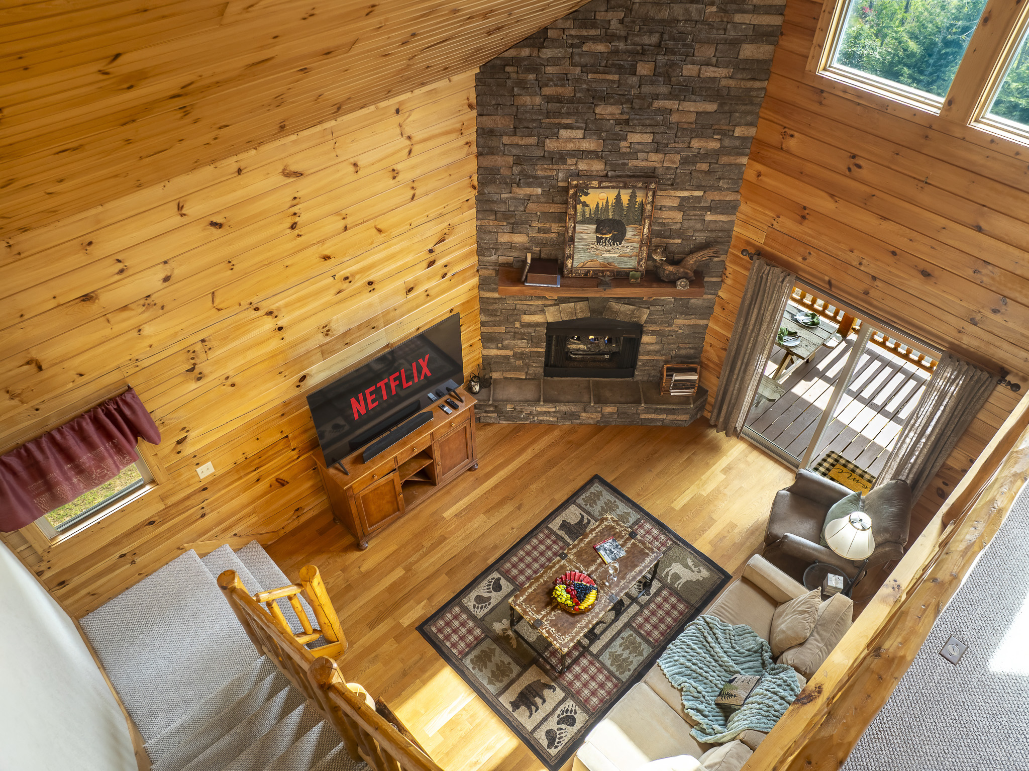 Living Room Oasis: Relax by the stone fireplace and enjoy movie nights with stunning views!