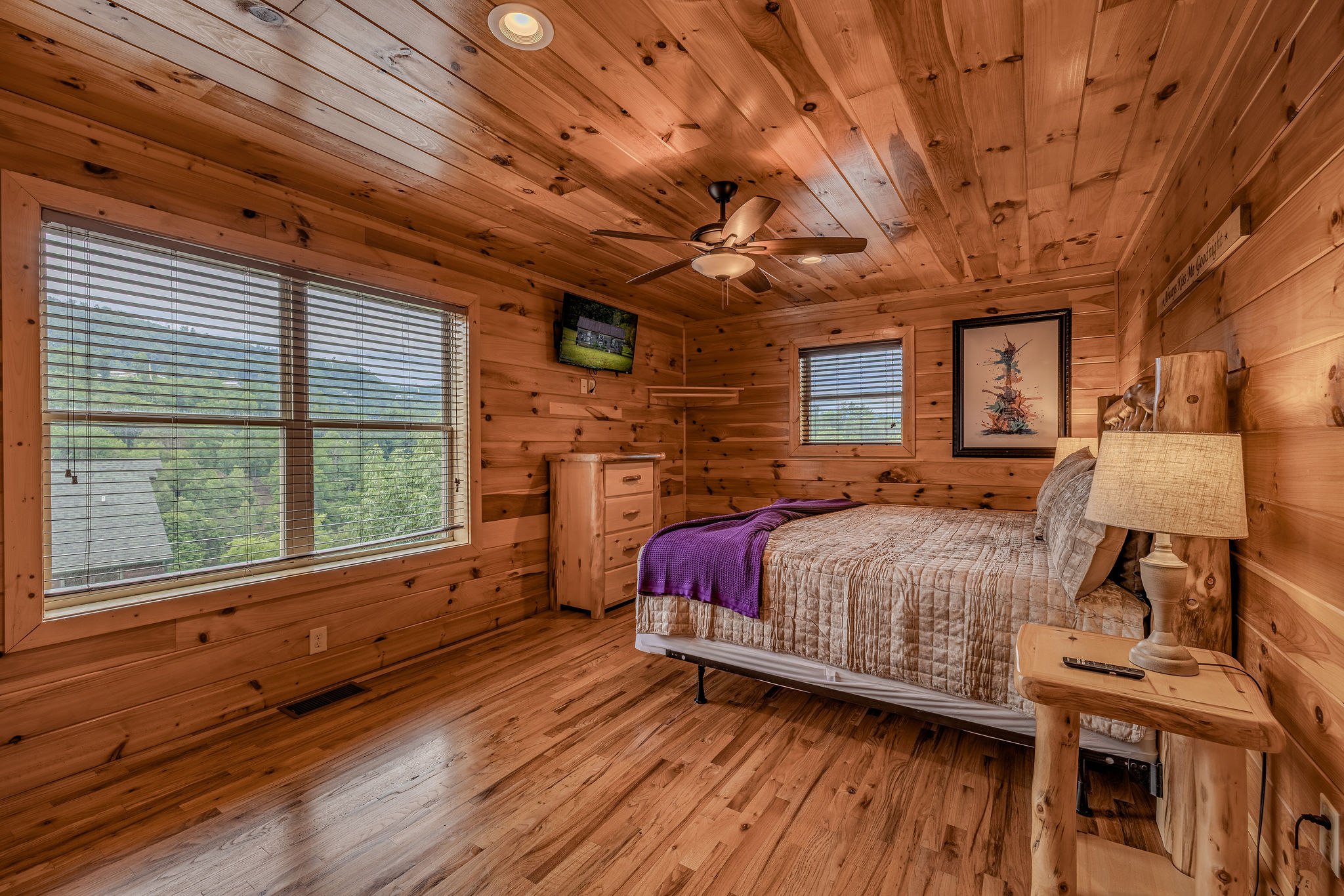 The Acoustic Suite is an upper-level king retreat with warm wood, private en-suite bathroom access, and relaxed mountain-music character.