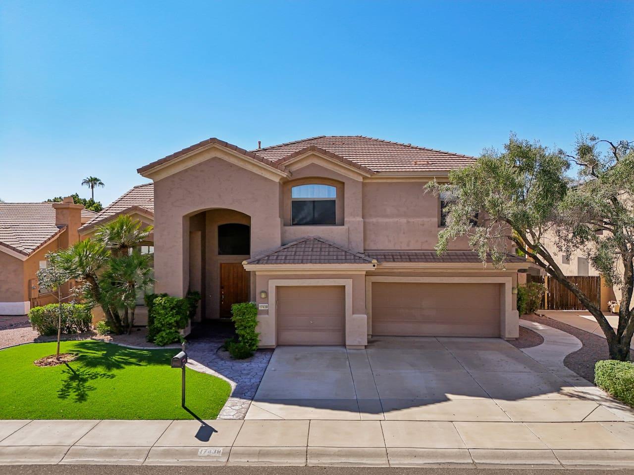 Arrive in style! Beautiful façade with a large entryway, manicured lawn, and a wide driveway—ample parking for the whole group.