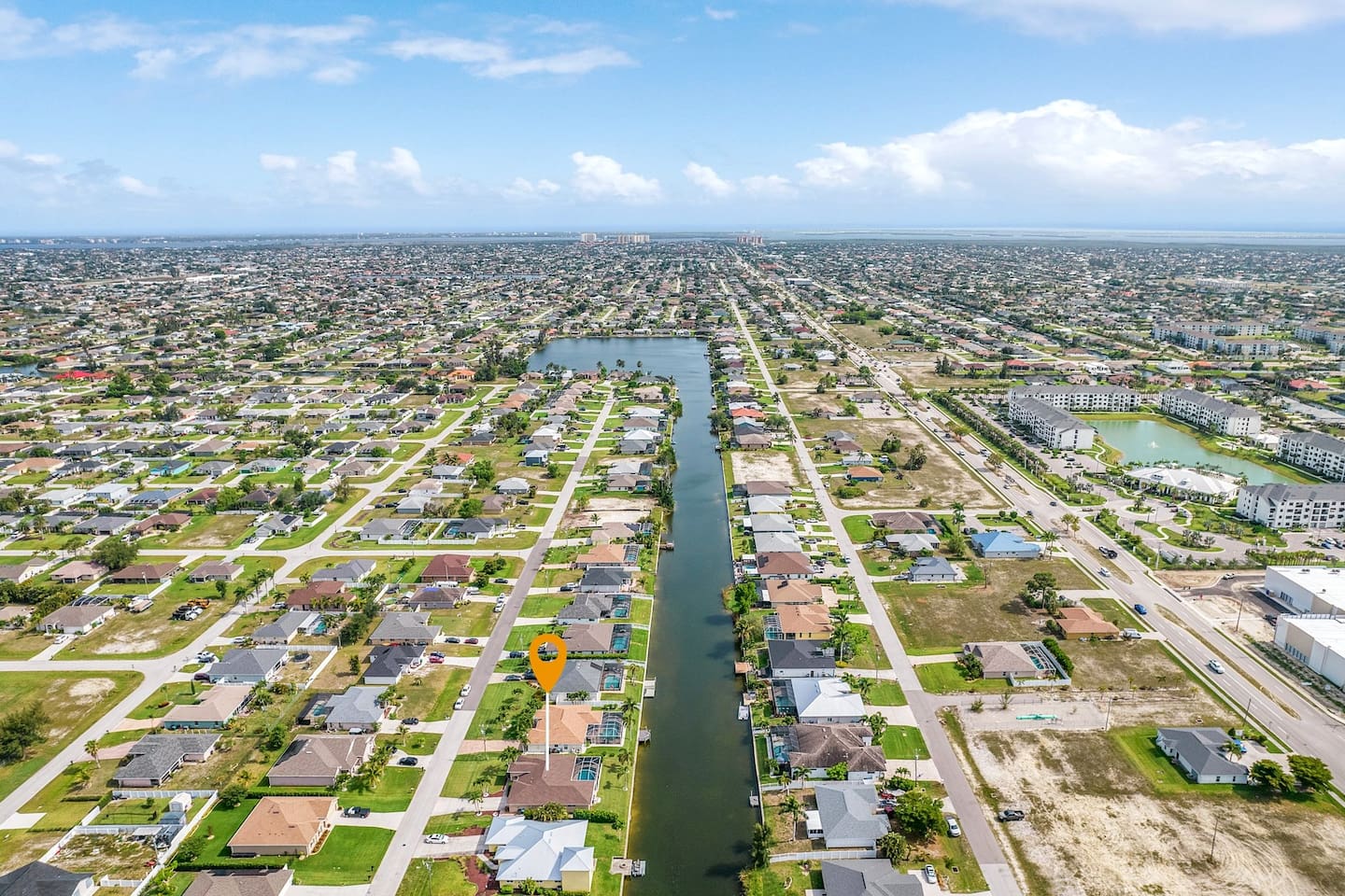 A stunning aerial view of your private pool, hot tub, and canal-front escape!