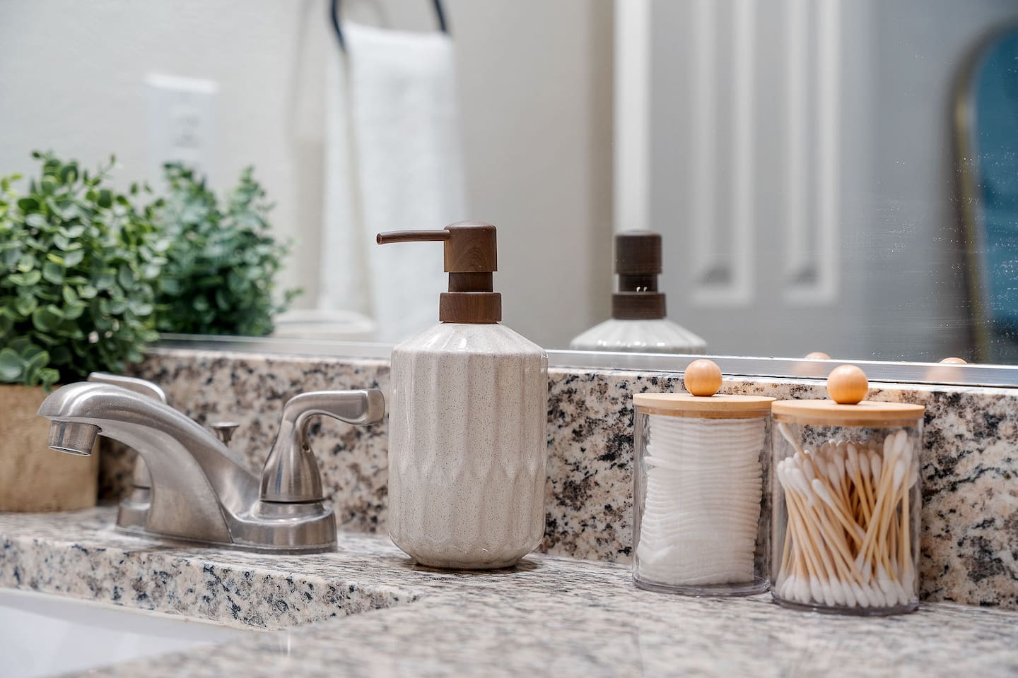 The bathroom features a clean and organized vanity with essential toiletries. Elegant fixtures and decor enhance the space.
