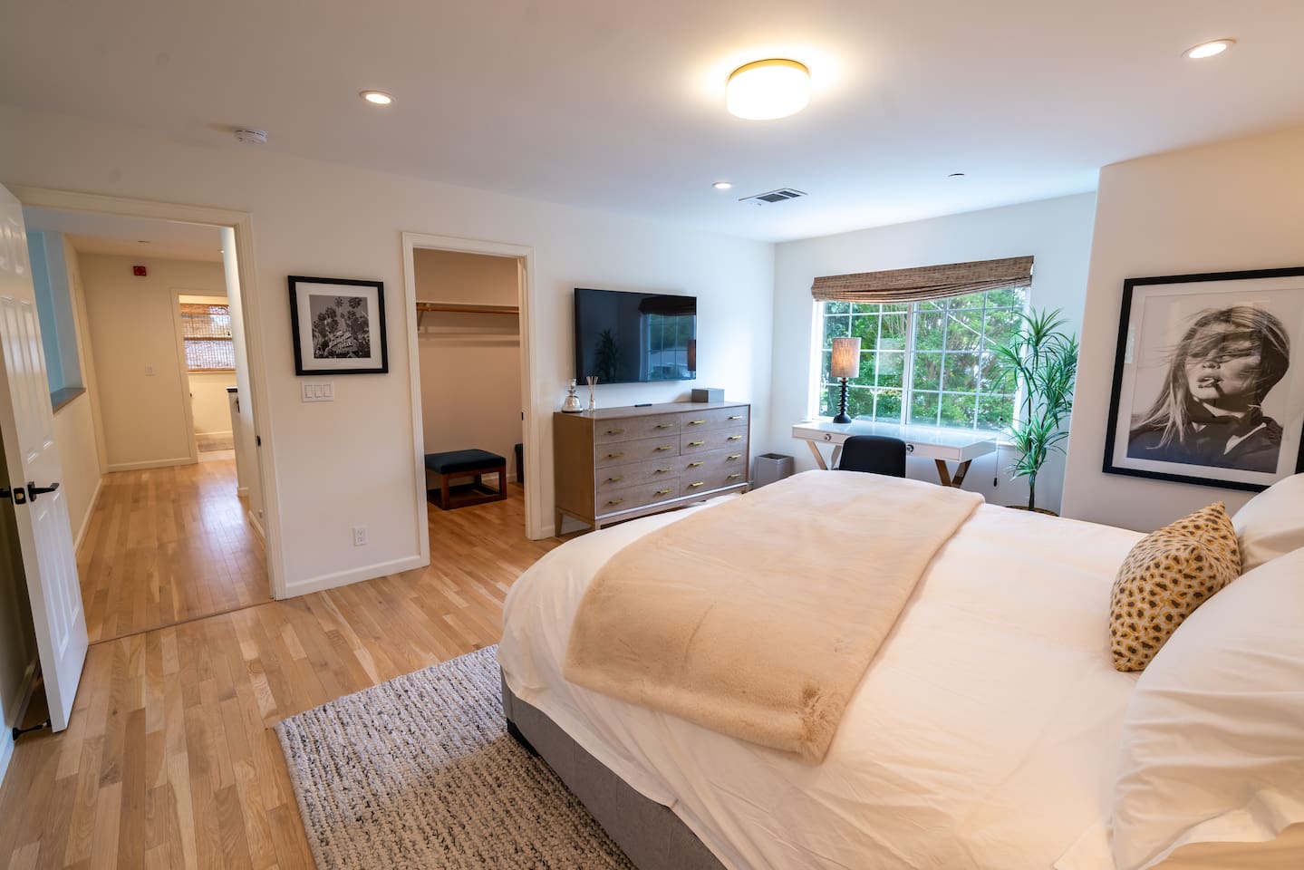 Pimary bedroom with smart TV and work area