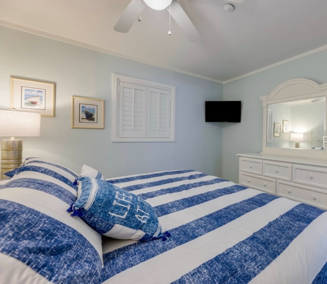 King bedroom with TV and dresser