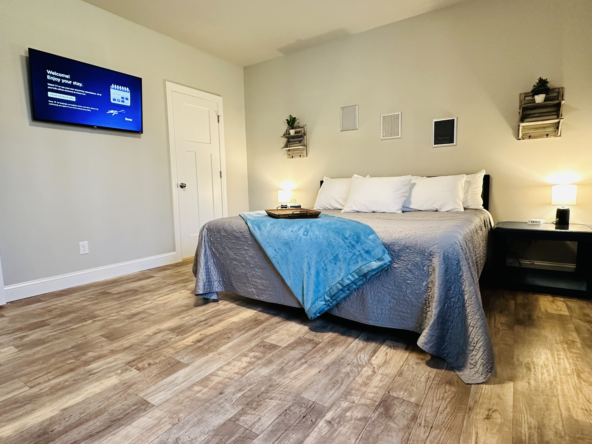 King Bed with comforter, an extra blanket, and five hypoallergenic pillows.