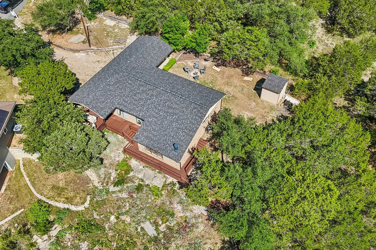 Aerial overview of the home, yard, and waterfront.