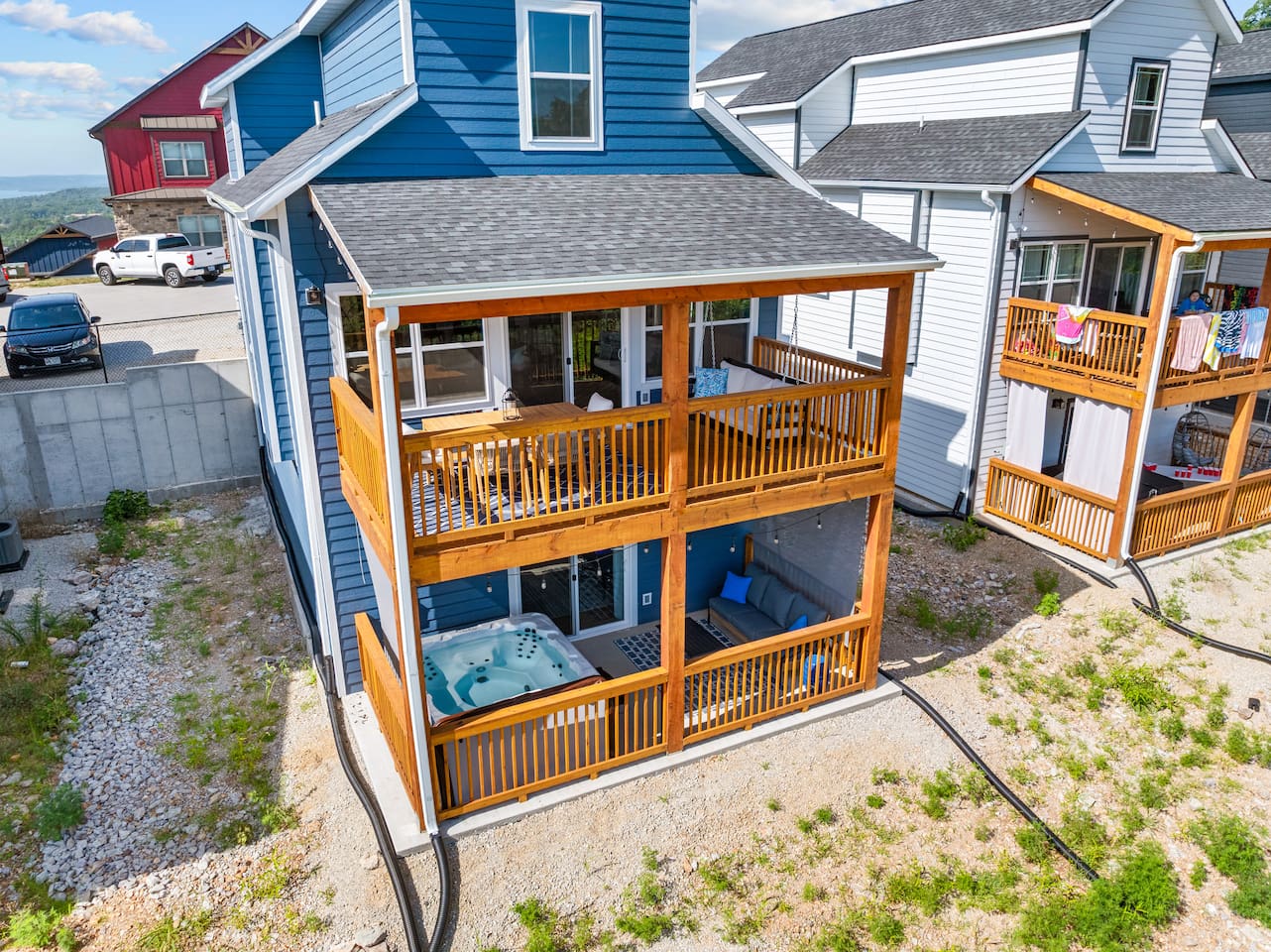Relax after a long day in our 2 fenced in areas with private hot tub, dining area, and swinging bench.