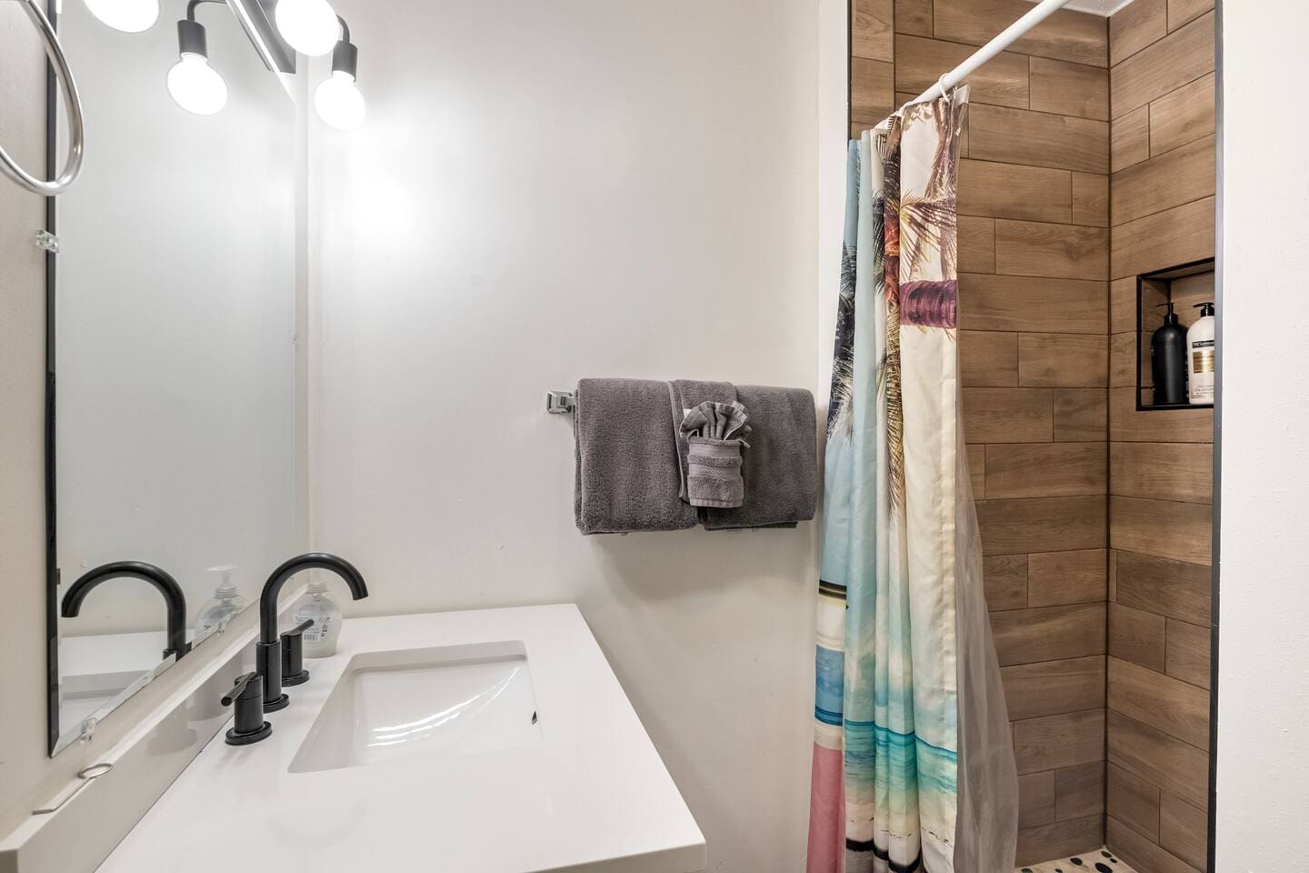 Guest Room suite with 1-queen bed. Beach Wagon themed room and private bathroom. 