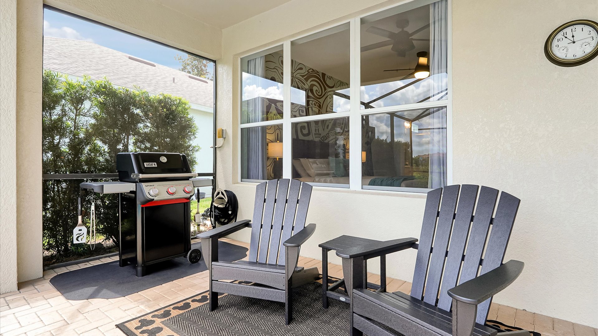 Covered Lanai: Relax in the Adirondack chairs or enjoy a family barbecue beside the private pool.