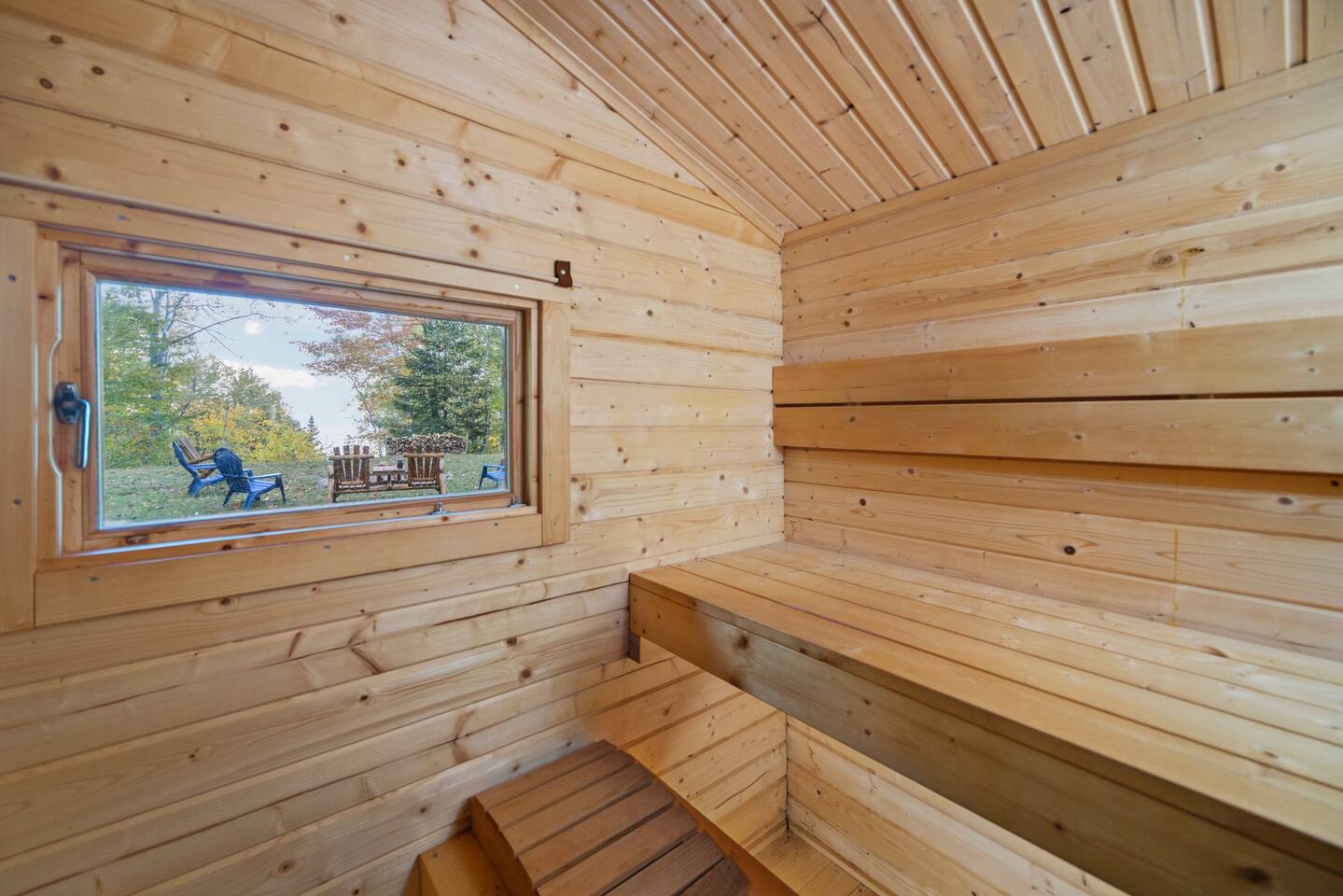 Inside the sauna, view of the upper campfire area and Lake Huron