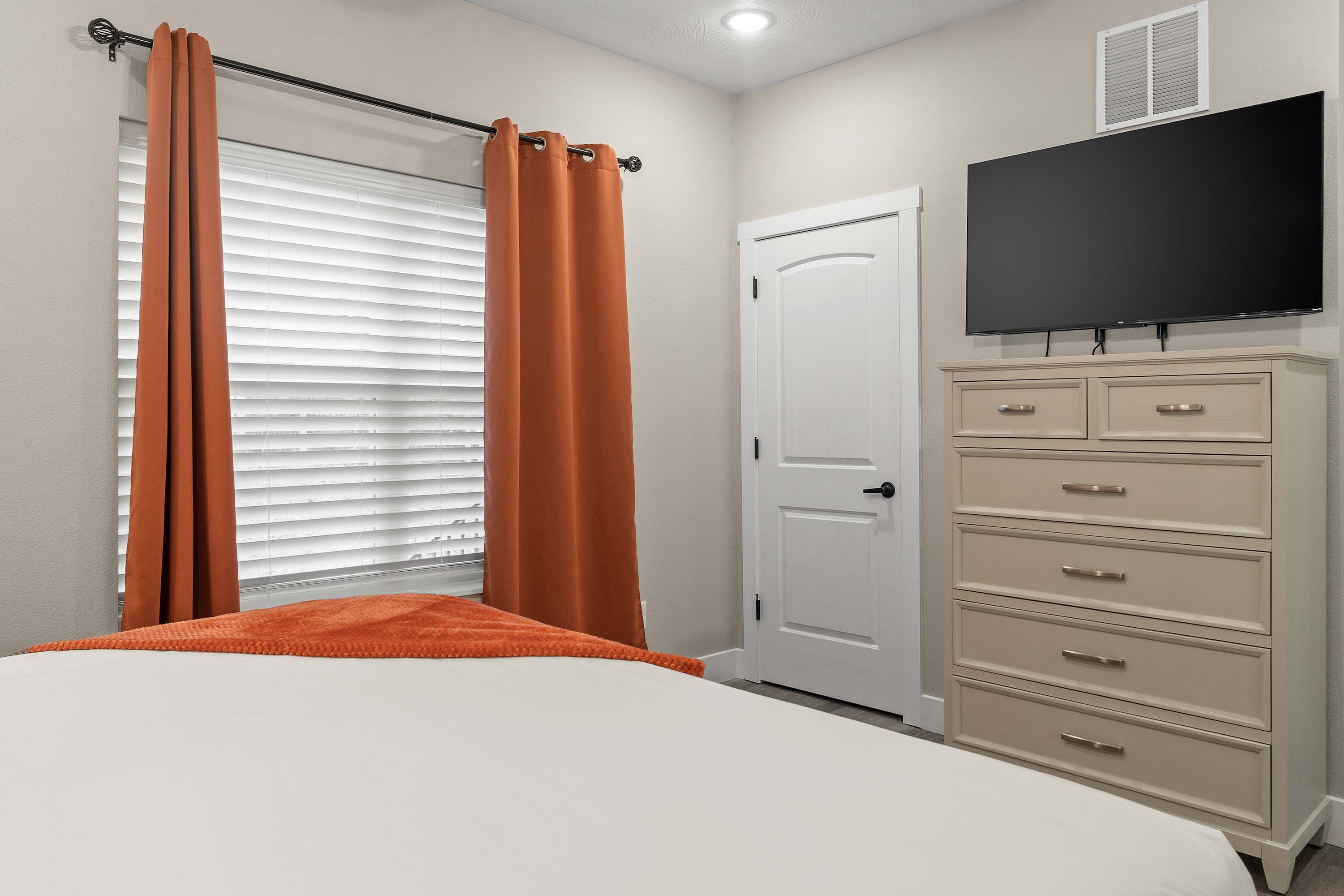 Master Bedroom #2 has large closet, dresser, TV and king size bed.