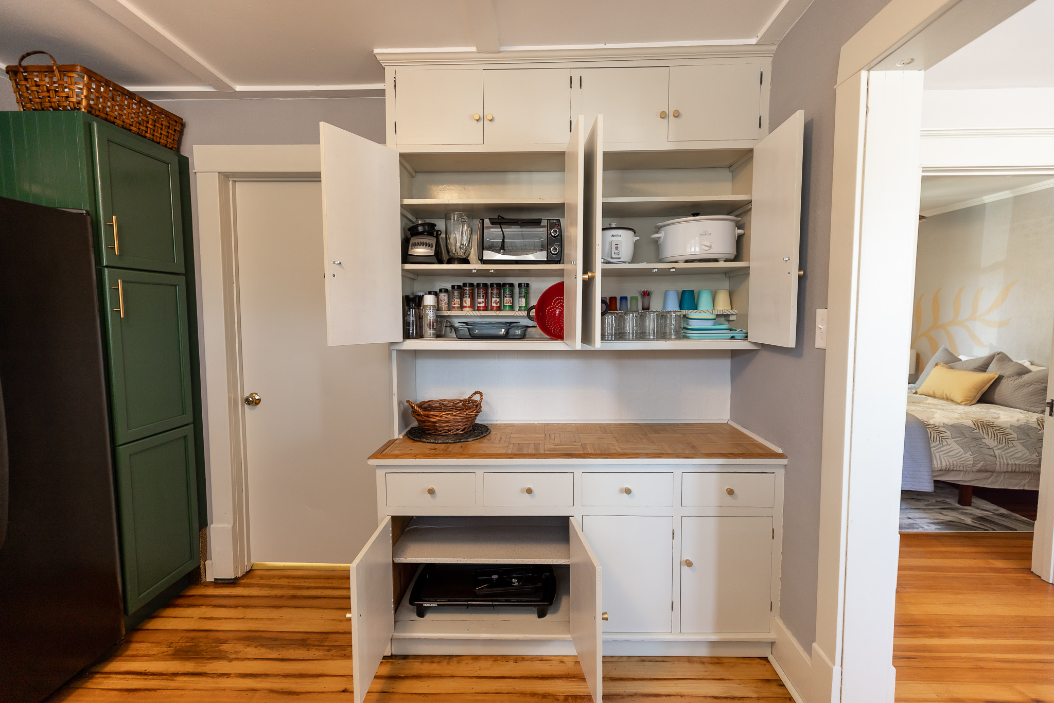 Blender, toaster oven, rice cooker, crock pot, kiddo plate ware, mason jars (our drinking glasses), an assortment of spices, coconut oil spray, pepper and pink Himalayan salt grinders. . .and