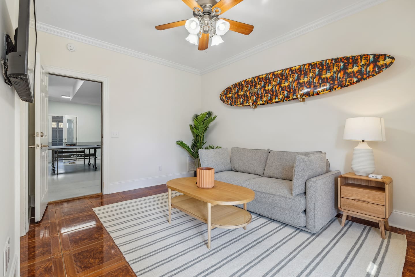 This room is located on the ground level, at the back of the home and functions as an extra living space with a tv, and also a bedroom with a private bathroom. The sofa is a pullout.