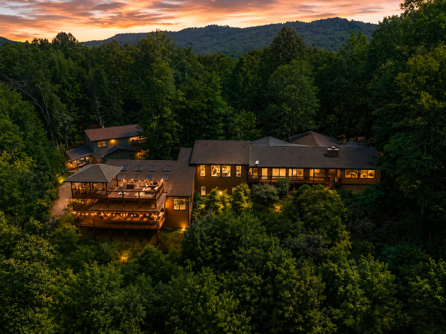 {Resort Exterior} Canopy Club glows at sunset with complete privacy, layered outdoor spaces, and sweeping forest views.