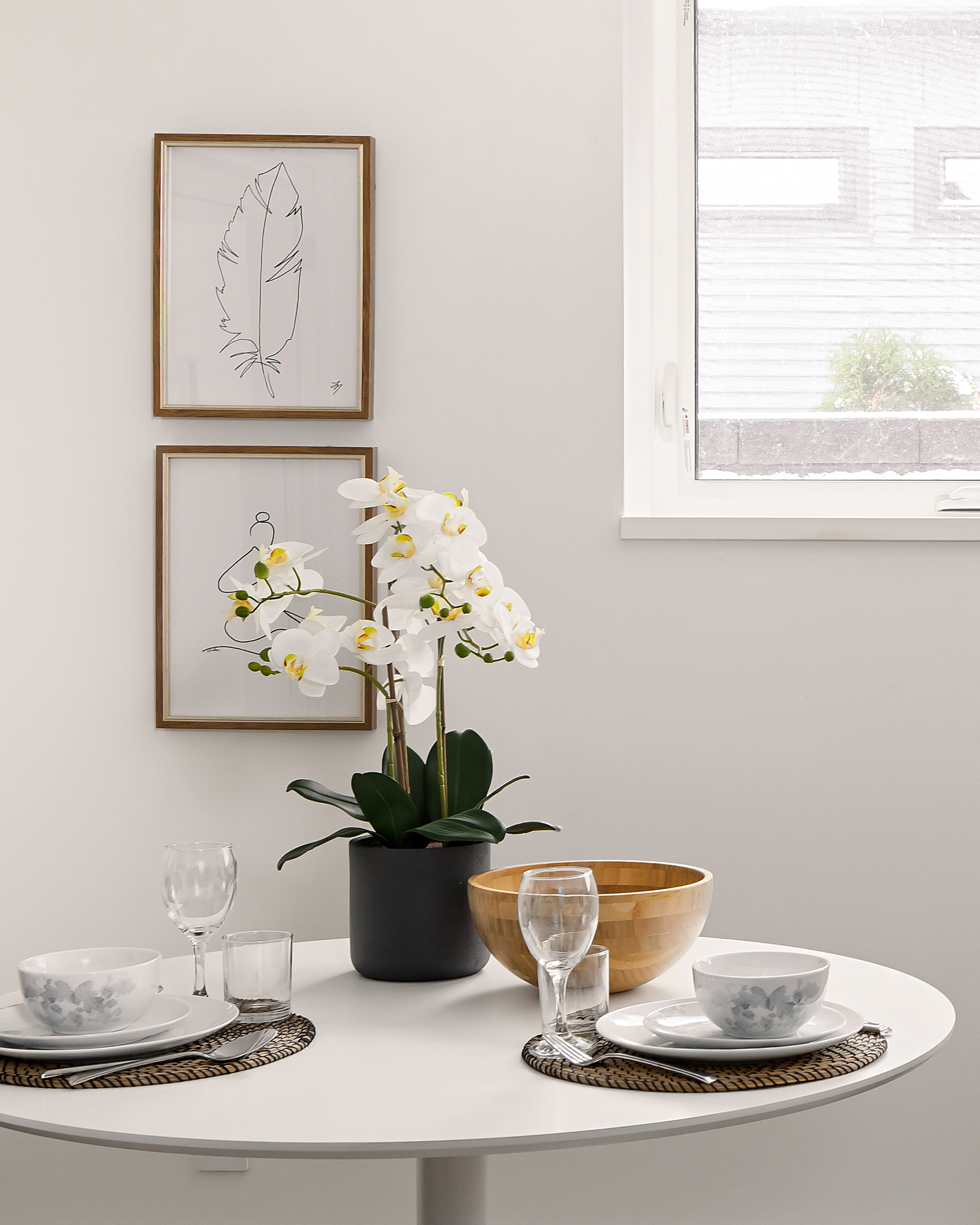 Thoughtfully set dining table with simple, modern place settings.