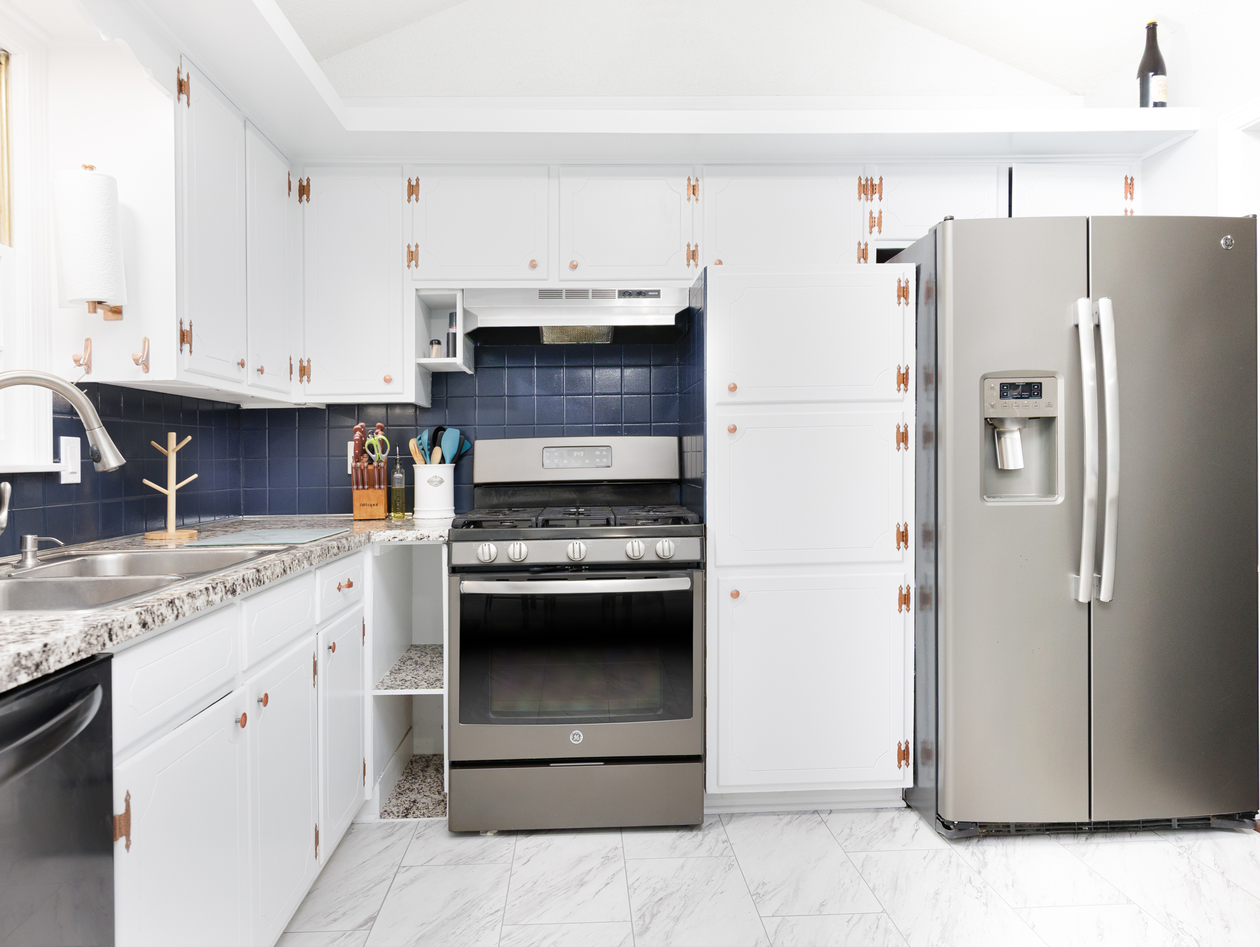 Modern kitchen appliances including refrigerator, stove, and dishwasher for a convenient stay.
