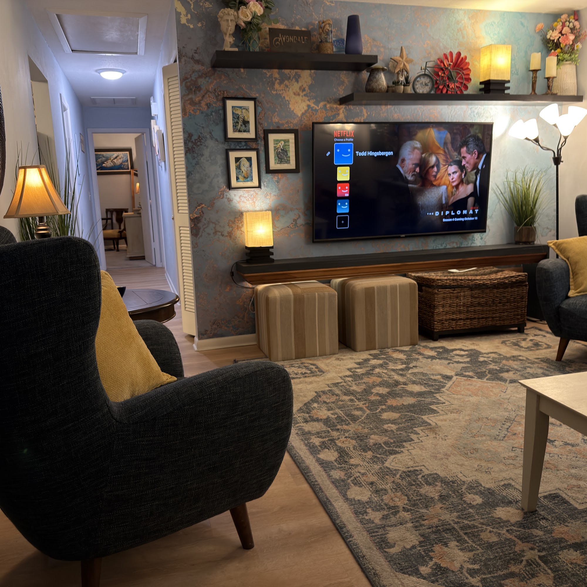 Living room seating with 65" TV and floating shelves