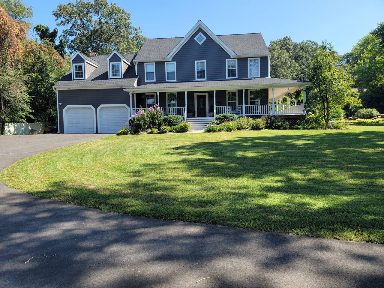 House front has large driveway, large grass yard, with a nice view from the large wrap around porch. 
