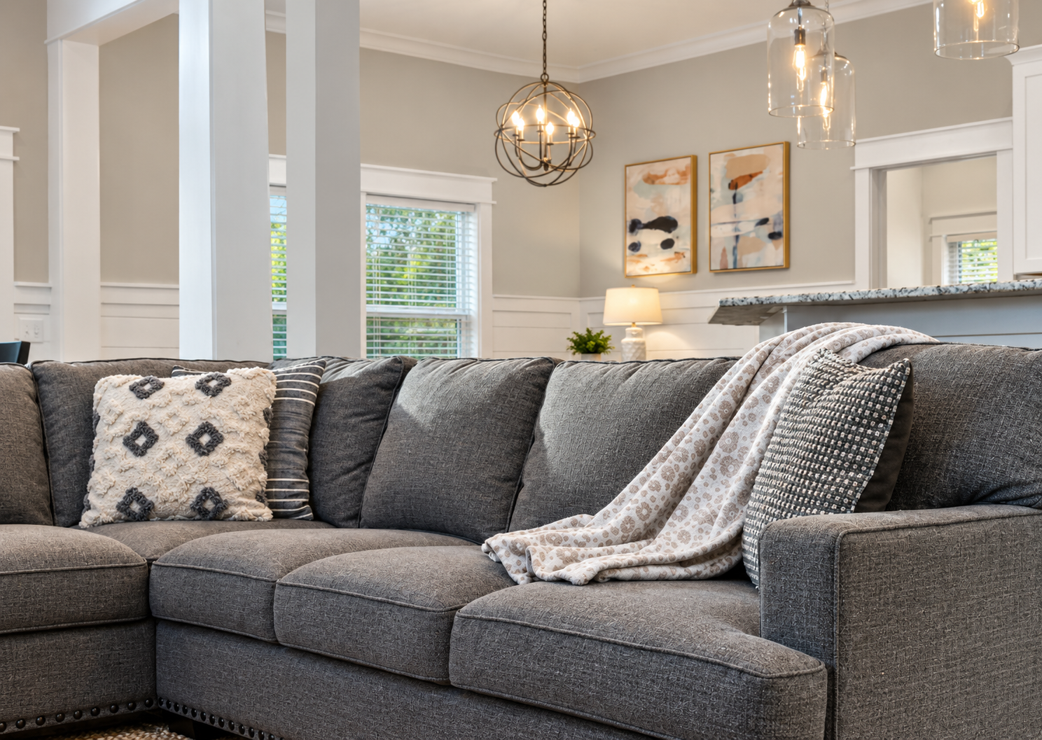 Relax and unwind in this spacious living room, featuring comfortable seating, coastal inspired décor, and plenty of room for the whole family.