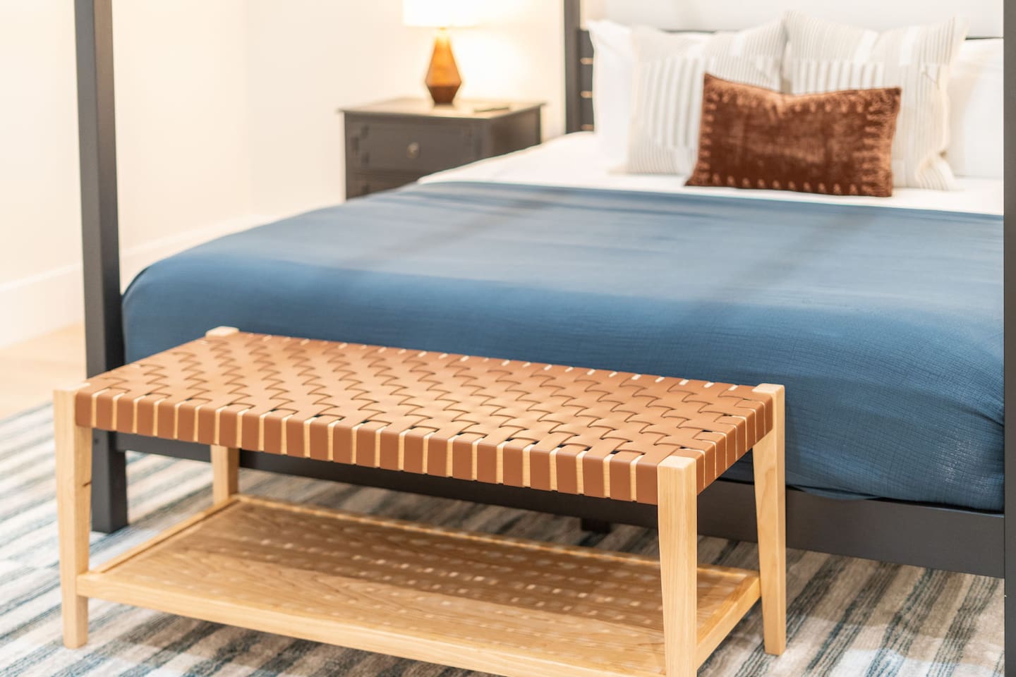 Bench seating at the foot of the bed adds comfort and functionality to the space.
