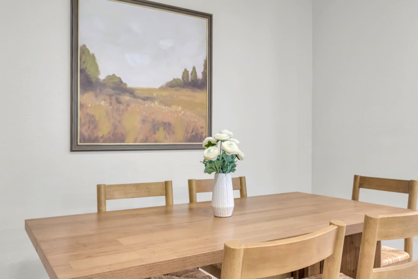 Warm dining area with a spacious dining table and seating for 8, perfect for shared meals and long-term stays. A calm, modern setting that flows easily into the home’s single level layout.